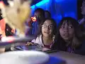 Girls watching 3D image of a seashell